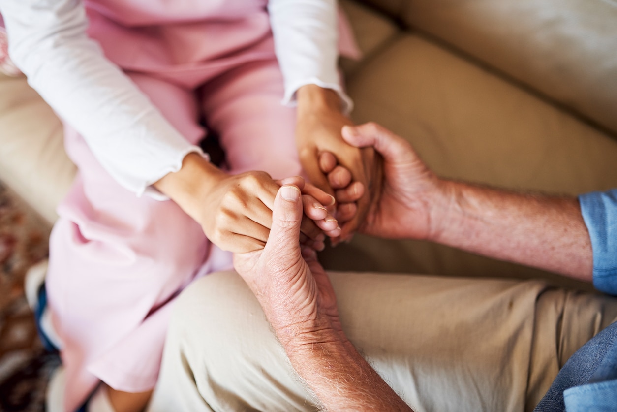 holding hands on couch