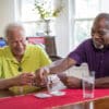 Man with HomeSafe Cellular playing cards with a friend