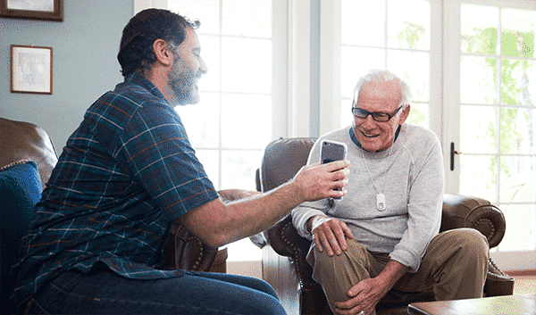 son showing his father his phone