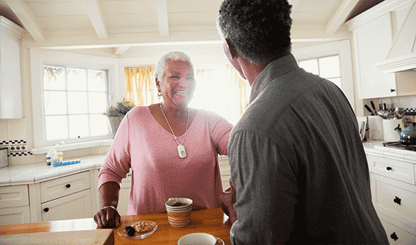 woman laughing in kitchen with her son