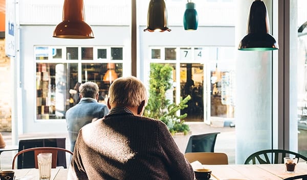 man sitting in cafe window