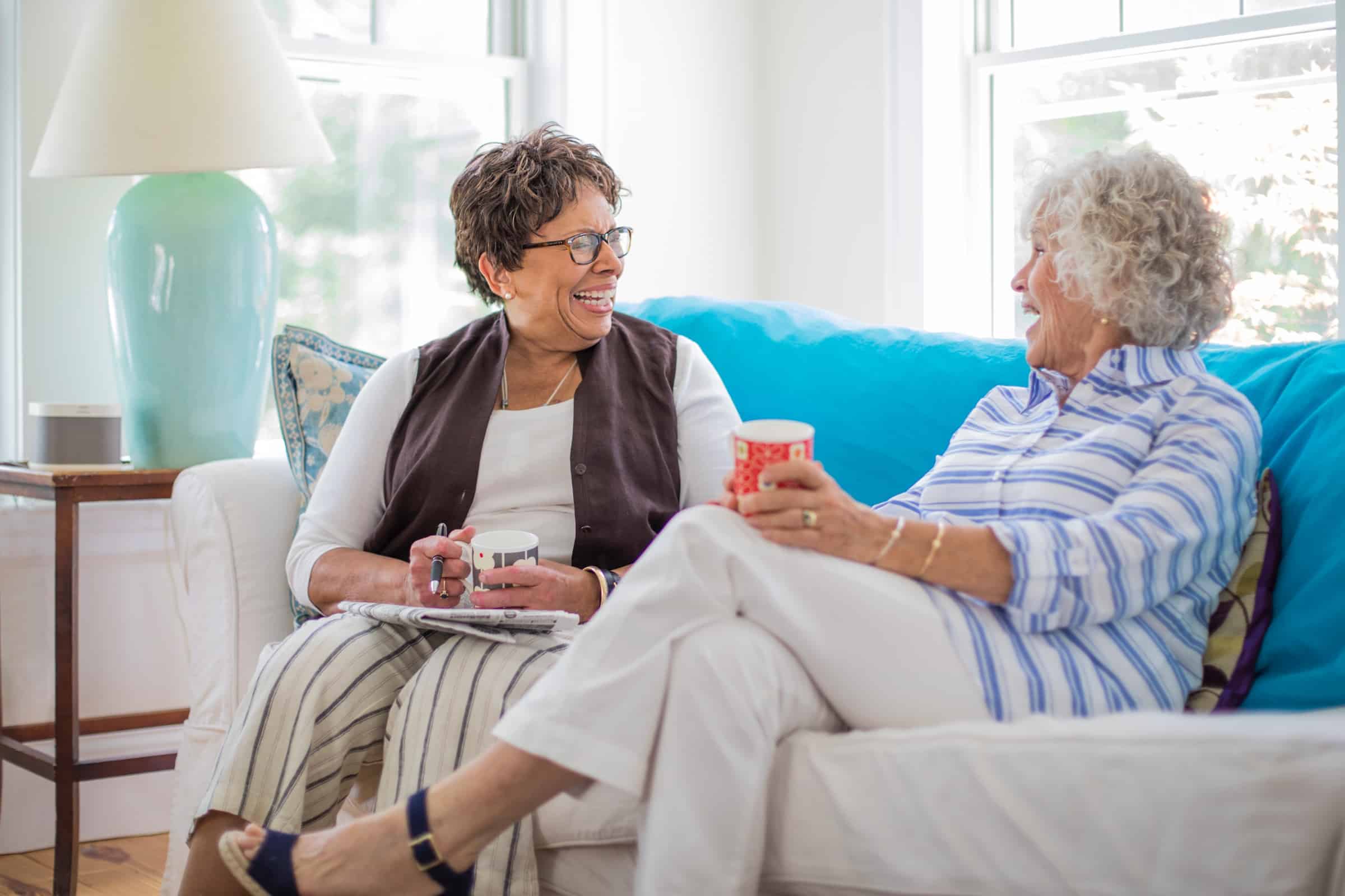 Women Sitting on Couch with Coffee