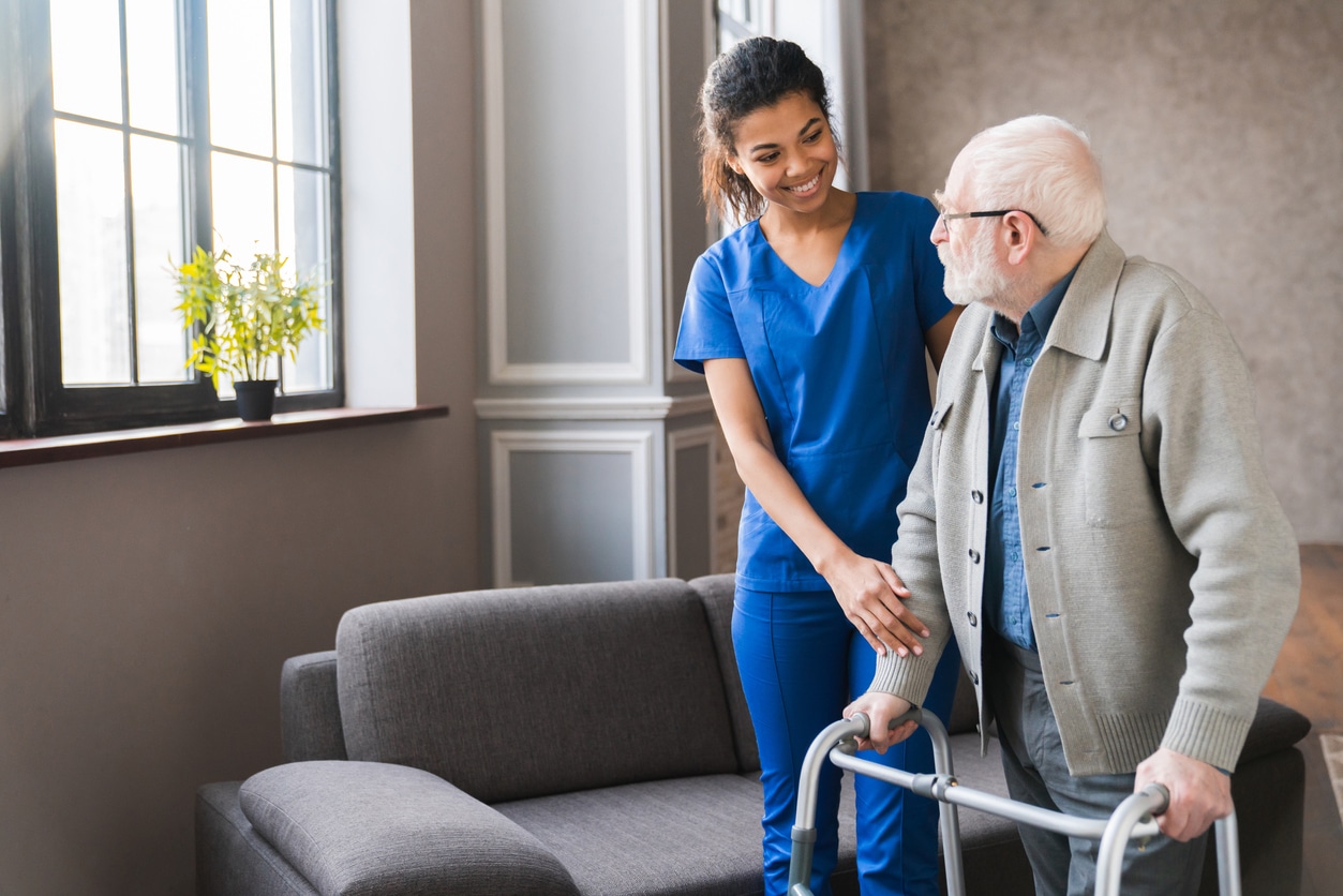 Man with walker and nurse