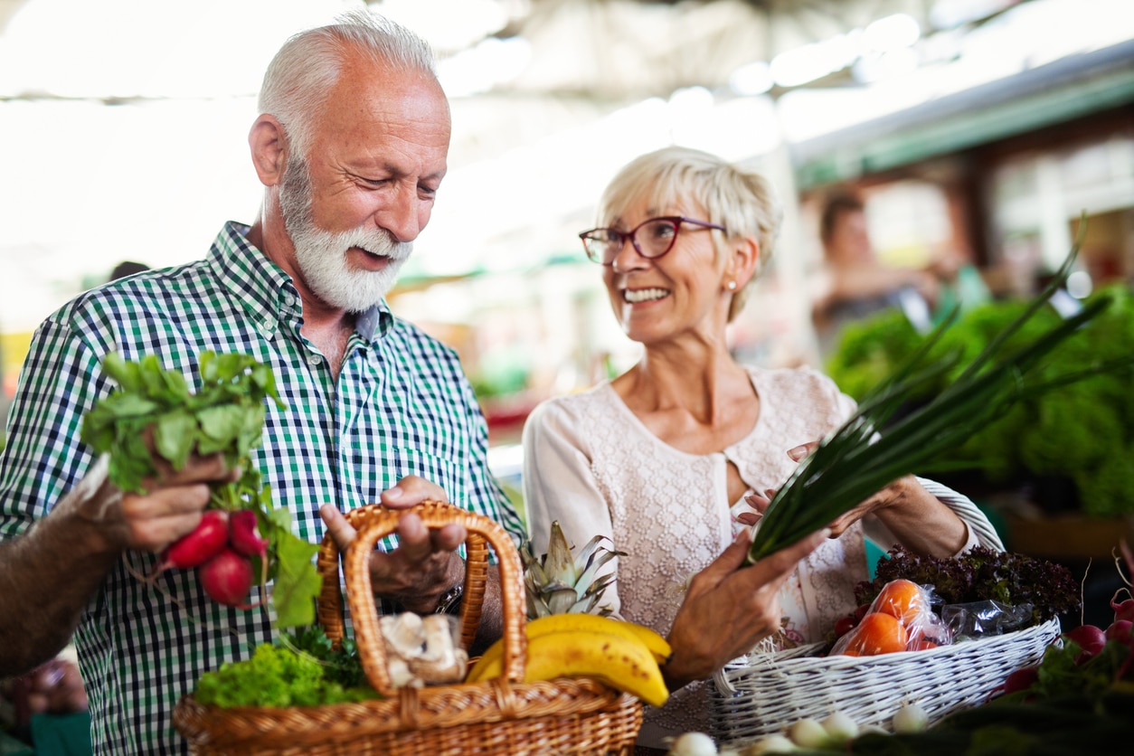 Man and Woman Buying Vegetables