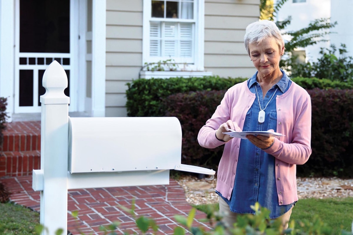 Woman with HomeSafe checking mail