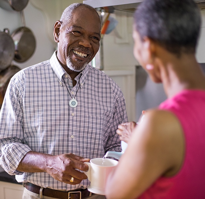 Man wearing HomeSafe drinking tea