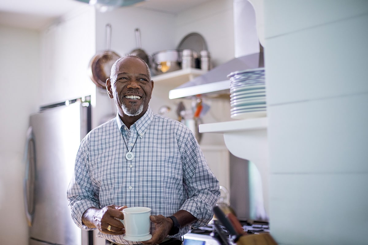 Man wearing HomeSafe drinking tea