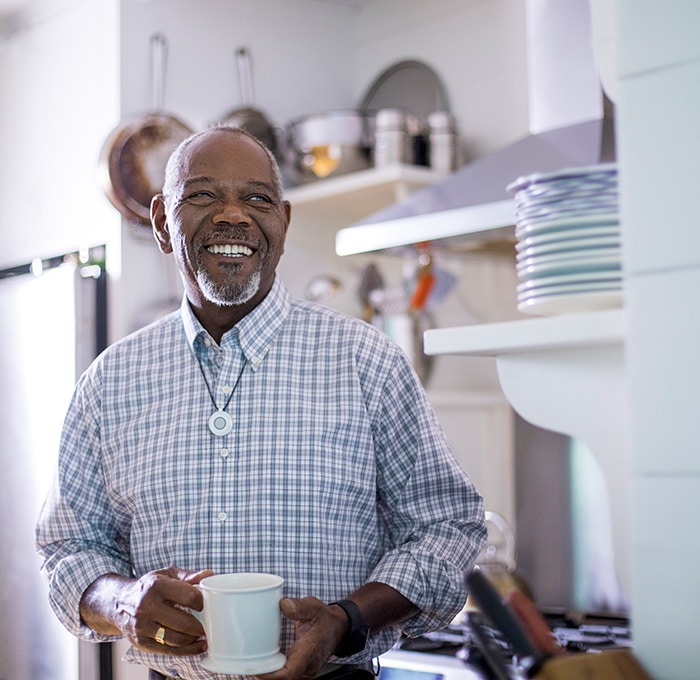 Man wearing HomeSafe drinking tea