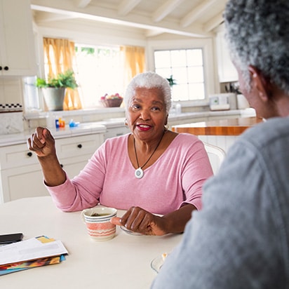 Woman drinking coffee with husband wearing HomeSafe