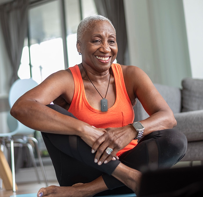 Woman Doing Yoga Wearing On the Go Medical Alert System with Fall Detection