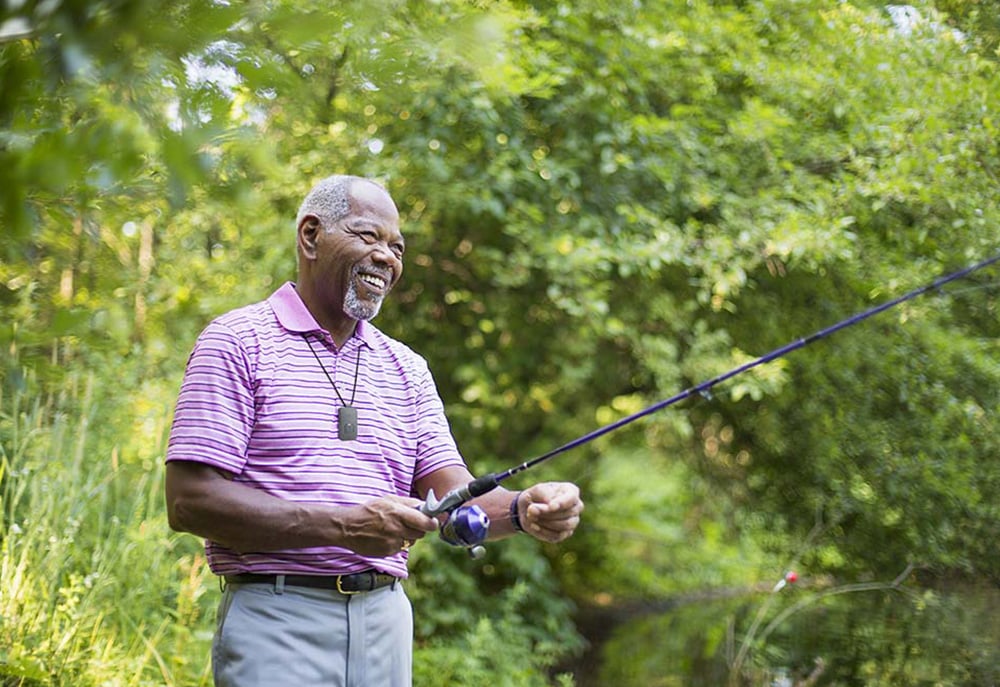 Man Fishing Wearing On the Go medical alert system with fall detection