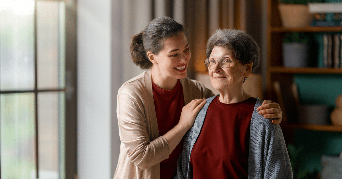Adult daughter calmly reassuring her mother after a fall