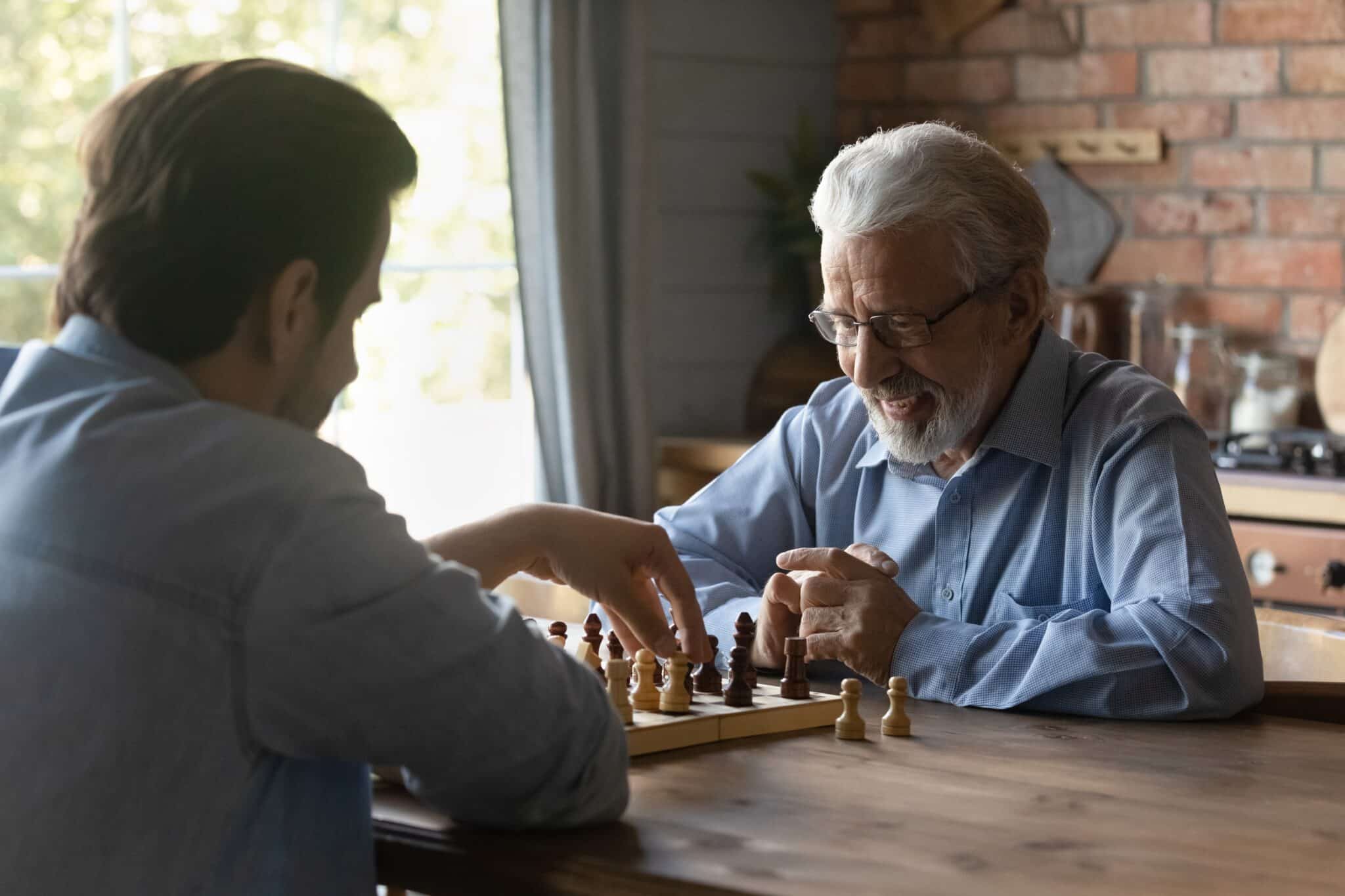 An adult child spending time with an aging parent at home