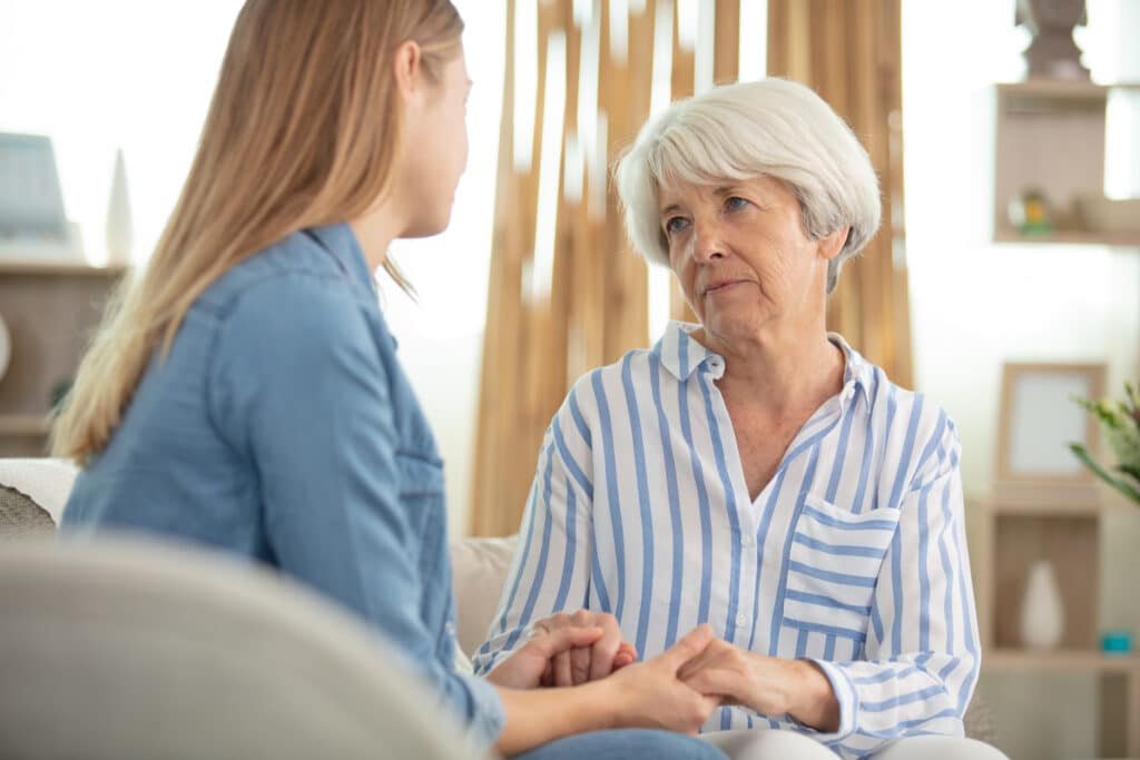 Younger woman offering emotional support to an older adult, highlighting mental health in seniors.