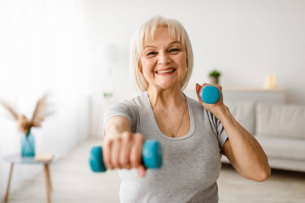Caregiver assisting an older woman with a walker for fall prevention for seniors.